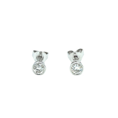 A pair of 18ct white gold bezel set stud earrings with round brilliant cut diamonds.