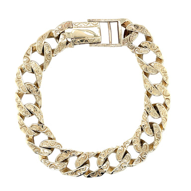 A 9ct yellow gold curb link bracelet with a patterned and bark effect finish, featuring a fold clasp.