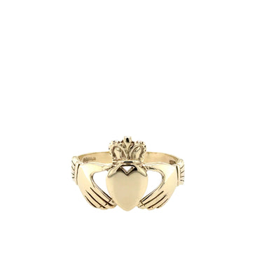 Gold Claddagh ring on a white background